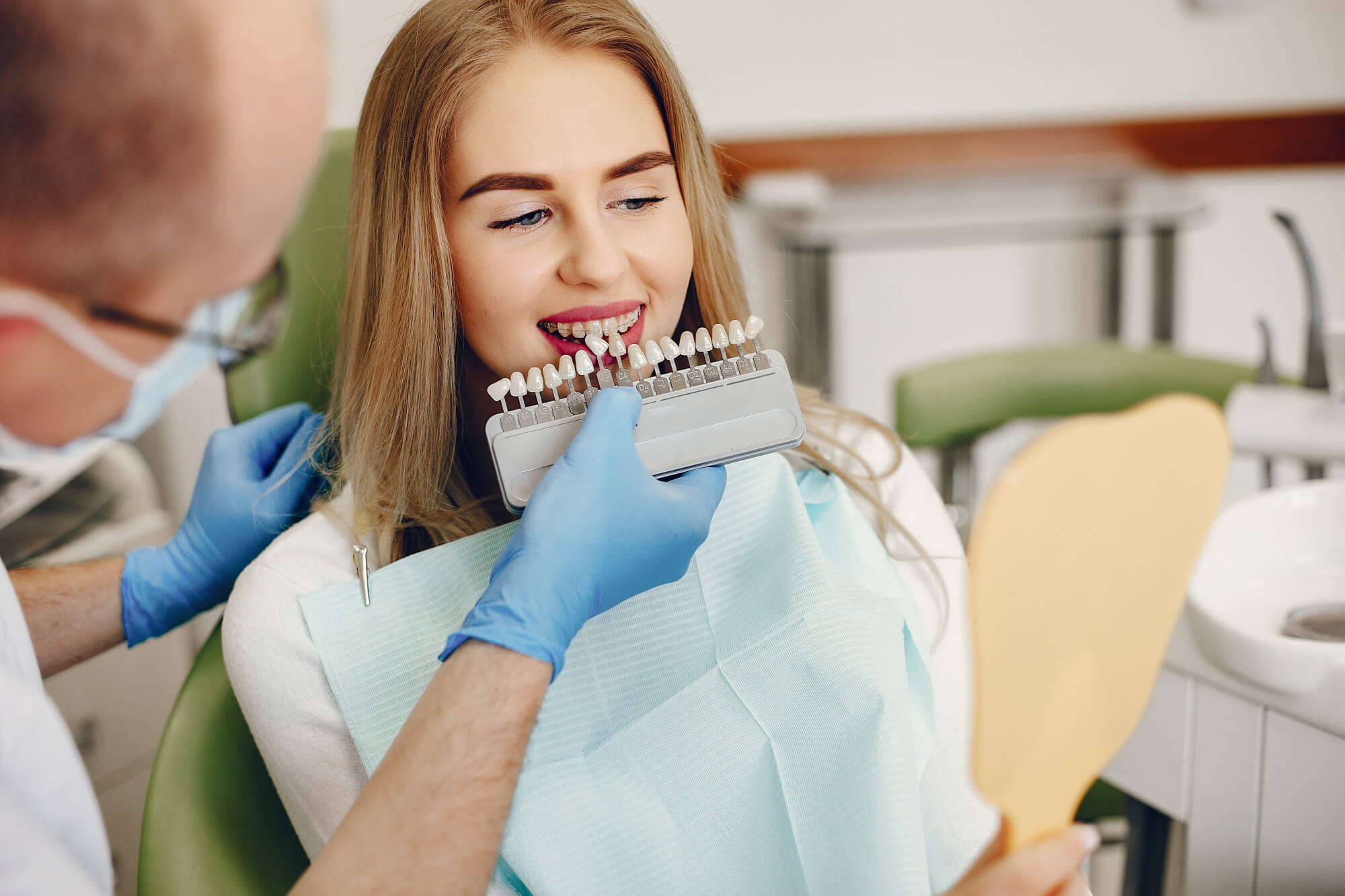 dentist showing veneers to patient