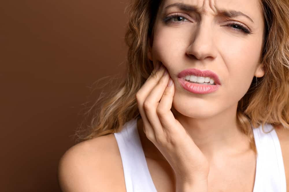 Woman experiencing a dental emergency