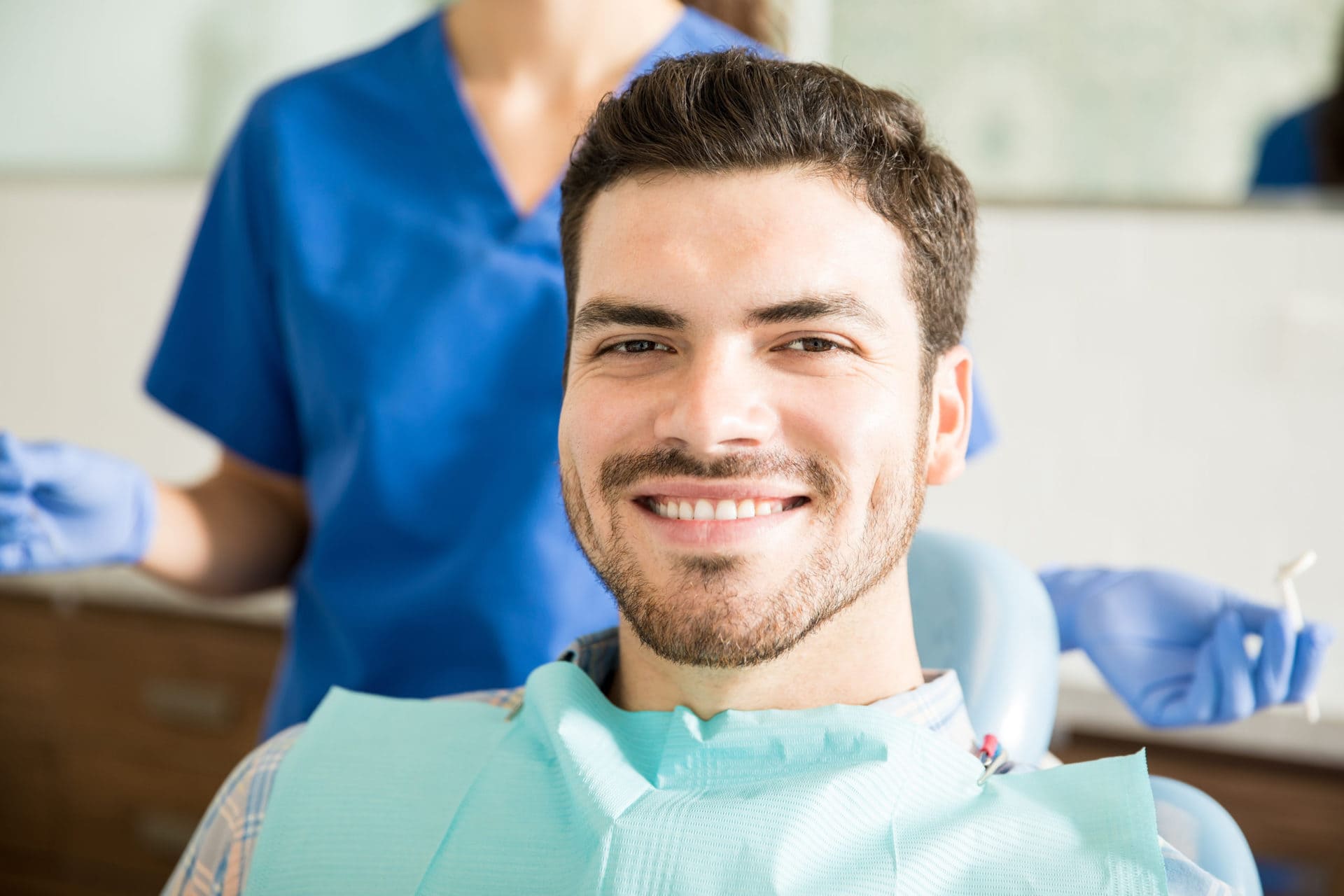 Portrait,Of,Smiling,Mid,Adult,Man,With,Dentist,Holding,Dental