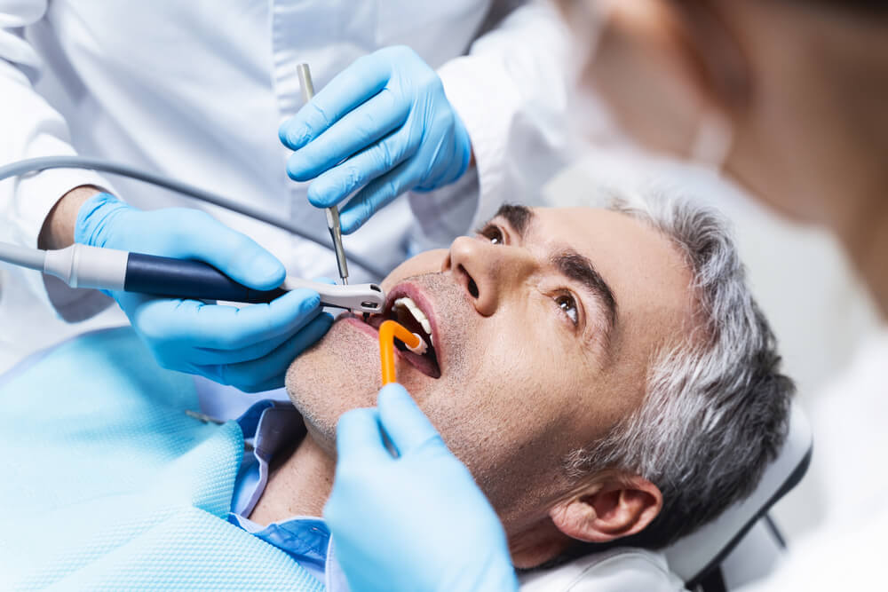 man getting root canal in dentist chair