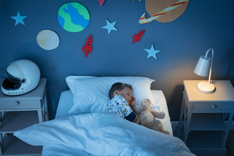 Child with sleep apnea sleeping in their bed