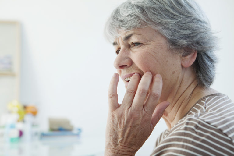 Woman realizing she has gum recession